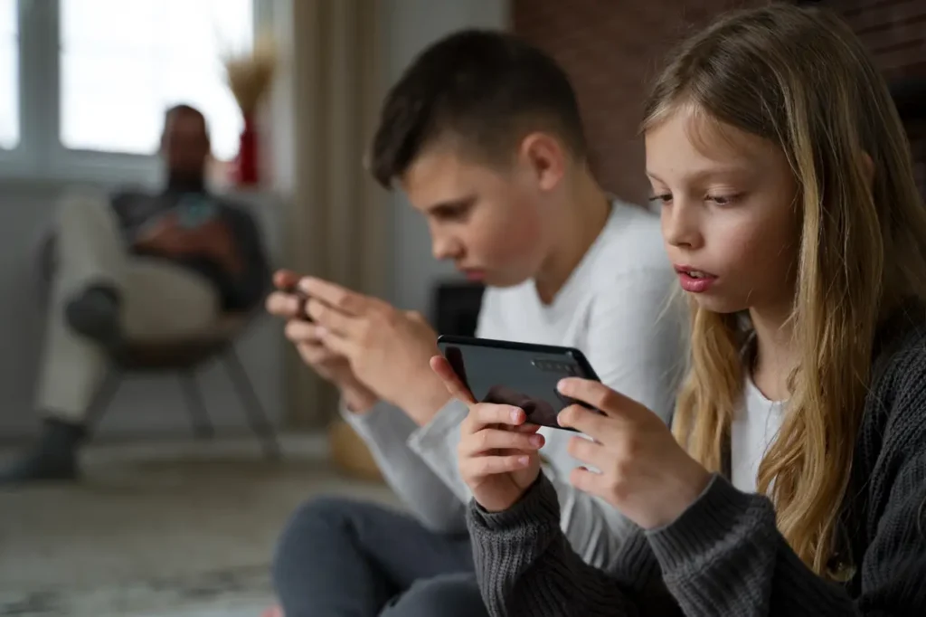 Young boy and girl on mobile problem gambling-Parents Standing Together