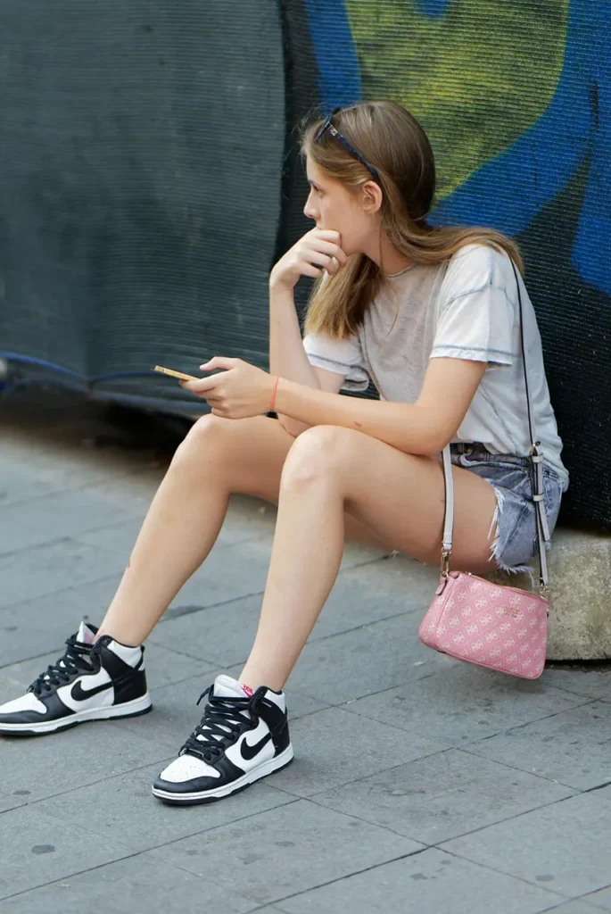 Girl placing a gambling bet on mobile - Parents Standing Together