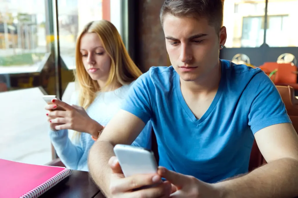 Young man sports betting in cafe-Parents Standing Together